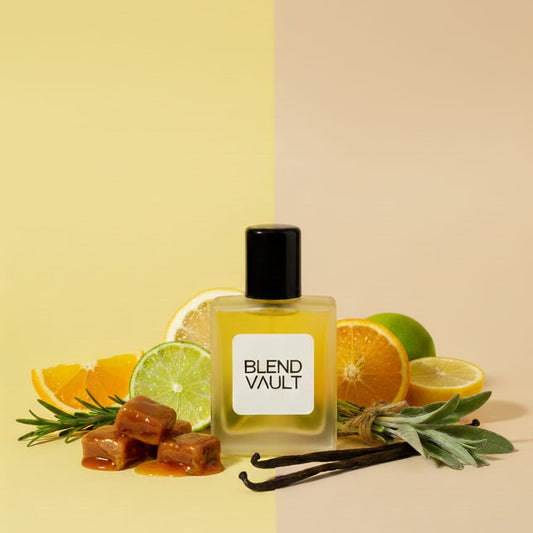 A bottle of BLEND VAULT perfume surrounded by ingredients: slices of orange and lime, vanilla beans, sprigs of rosemary or sage, and pieces of amber-colored caramel candy."